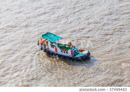 Tugboat brings cargo in Chao Phraya River Tugboat brings cargo in Chao Phraya River 37499483