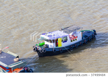 Tugboat brings cargo in Chao Phraya River Tugboat brings cargo in Chao Phraya River 37499484