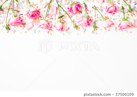 Floral frame made of pink flowers and bright candy 37500109