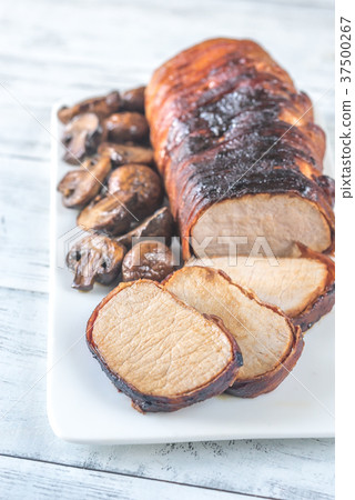 Pork loin wrapped in bacon with roasted mushrooms 37500267