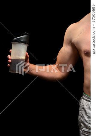Sports nutrition in hands bodybuilder 37500699