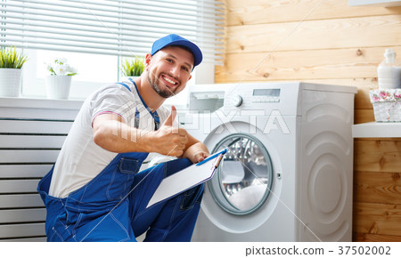 working man   plumber repairs  washing machine in   laundry 37502002