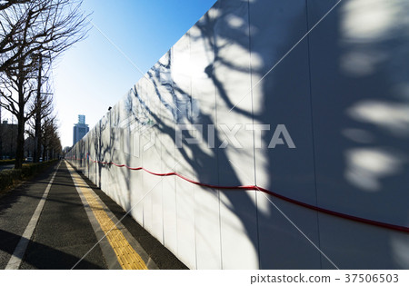 Construction fence and shadow of trees 37506503