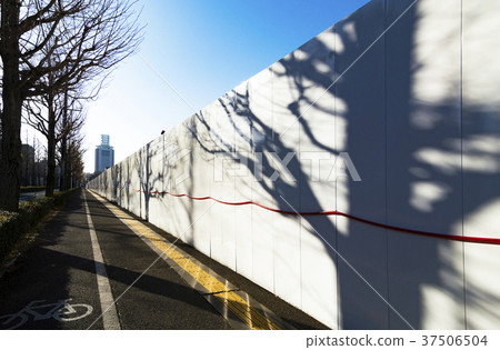 Construction fence and shadow of trees 37506504