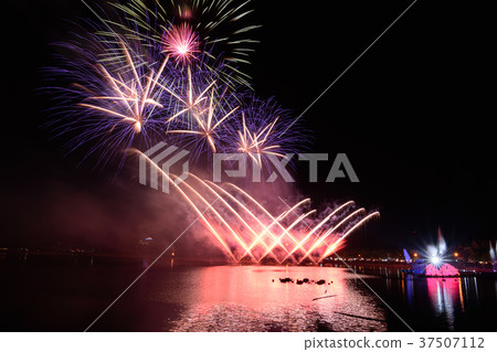 Bright and colorful firework against a black night 37507112