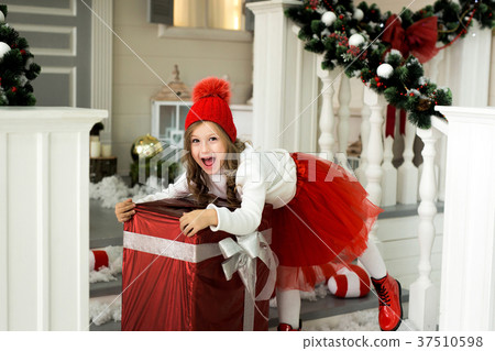 Happy girl holding a big box with a gift 37510598