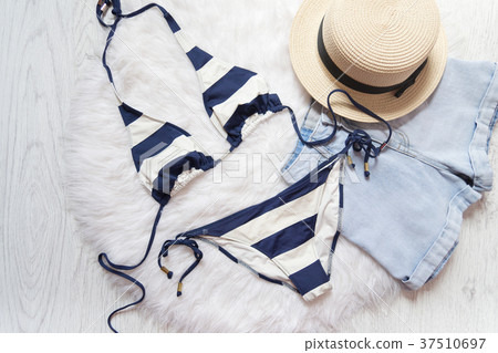 Beach concept. Striped swimsuit, straw hat, shorts Beach concept. Striped swimsuit, straw hat, shorts 37510697