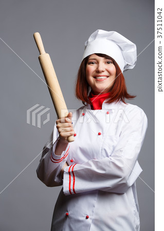 Picture of brunette chef in white robe and cap Picture of brunette chef in white robe and cap 37511042
