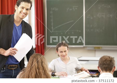 Teacher teaching or educate at the board a class 37511172