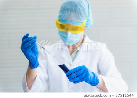 Portrait of laboratory scientist mixing chemical 37511544