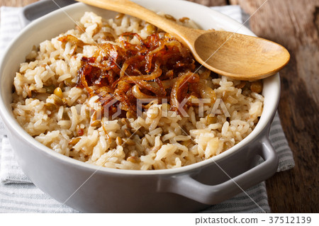 Stewed rice with lentils and fried onions close-up 37512139