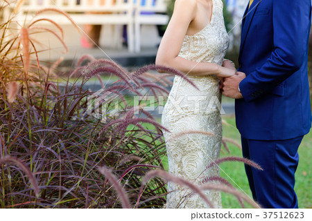 The bride and groom join hands. The bride and groom join hands. 37512623
