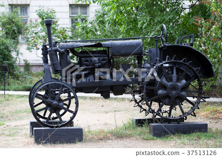 Old rusty tractor in a park. 37513126