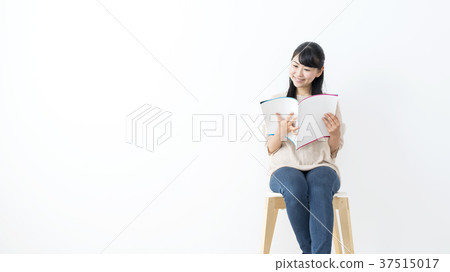 Young woman staring at catalog Young woman staring at catalog 37515017