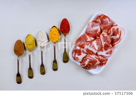 Fresh pork and spoons with different spices 37517306