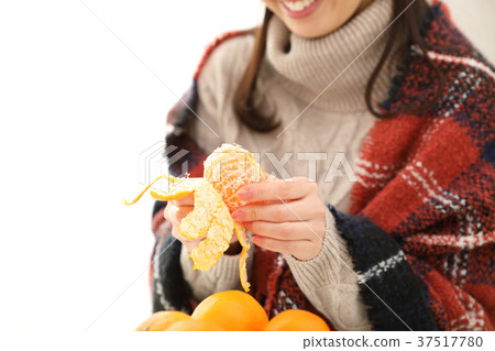 woman eating mandarin oranges woman eating mandarin oranges 37517780