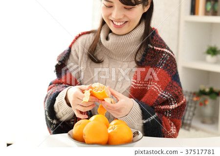 woman eating mandarin oranges woman eating mandarin oranges 37517781