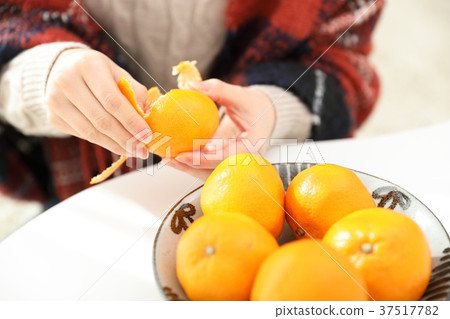 woman eating mandarin oranges woman eating mandarin oranges 37517782