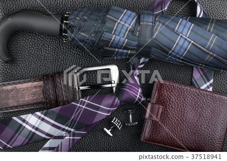Classic luxury accessories lying on black leather. Classic luxury accessories lying on black leather. 37518941