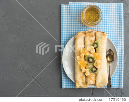 Delicious pancakes with banana, kiwi and orange 37519460