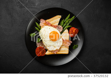 Fried egg with bread toast and asparagus Fried egg with bread toast and asparagus 37520132