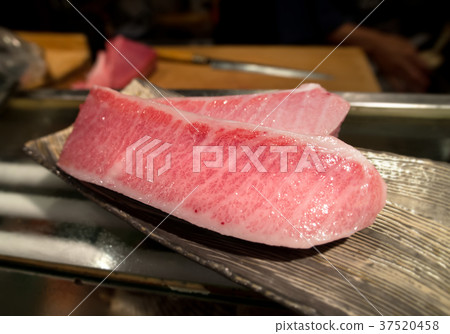 cutting of otoro from blue fin tuna for sashimi. cutting of otoro from blue fin tuna for sashimi. 37520458