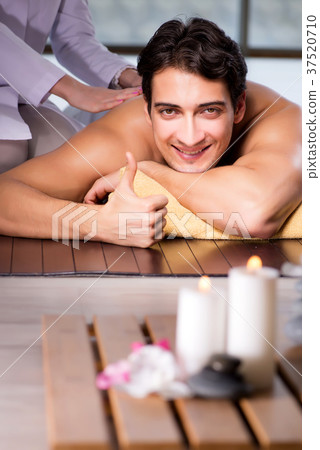 Young handsome man during spa procedure Young handsome man during spa procedure 37520710