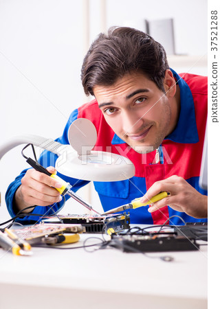 Professional repairman repairing computer in Professional repairman repairing computer in 37521288
