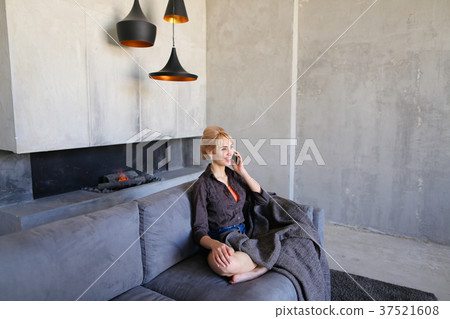 Beautiful girl reaches for phone and answers 37521608