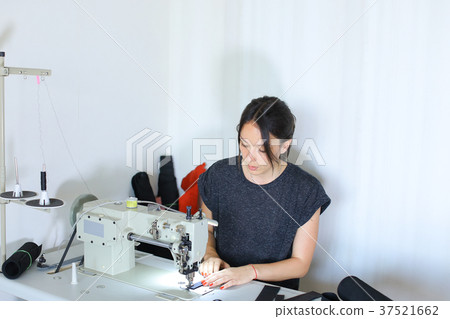 seamstress discussing work with boss using seamstress discussing work with boss using 37521662
