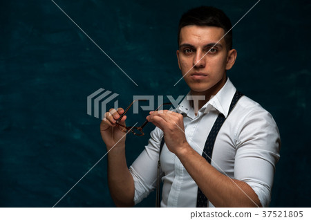 Attractive man posing on dark background Attractive man posing on dark background 37521805