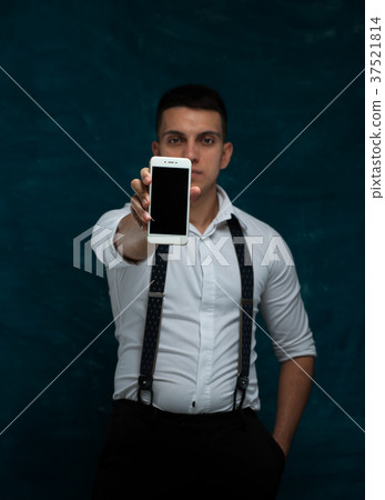 Attractive man posing on dark background Attractive man posing on dark background 37521814