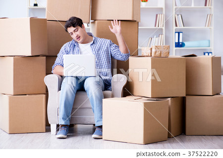Young man moving in to new house with boxes Young man moving in to new house with boxes 37522220