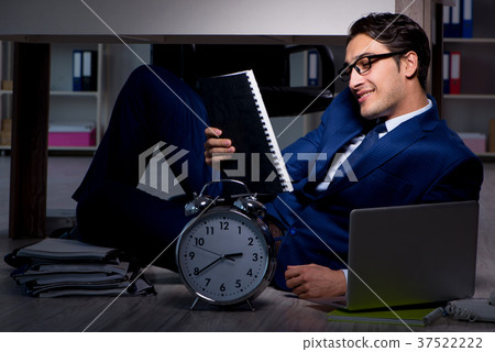 Businessman working overtime long hours late in Businessman working overtime long hours late in 37522222