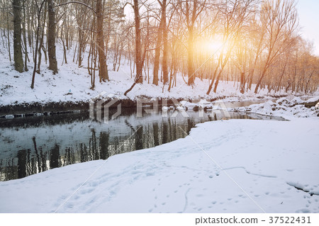 Winter landscape by a river in the sunset 37522431