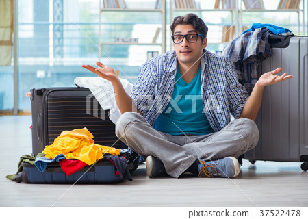 Young man preparing for vacation travel Young man preparing for vacation travel 37522478