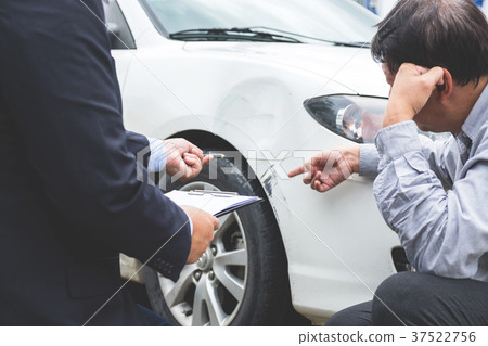 Man agent Filling Insurance Form Near Damaged and examining Car, Man agent Filling Insurance Form Near Damaged and examining Car, 37522756