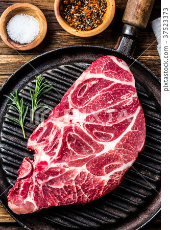 Raw marbled beef steak on grill pan 37523373