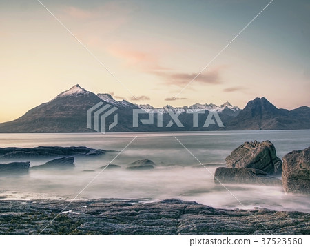 Rocky coastline in Elgol at sunset, cracked rocks 37523560