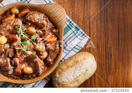 Beef Bourguignon stew served with baguette Beef Bourguignon stew served with baguette 37523833
