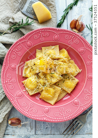 Ravioli with egg yolk, black pepper and parmesan. Ravioli with egg yolk, black pepper and parmesan. 37524351