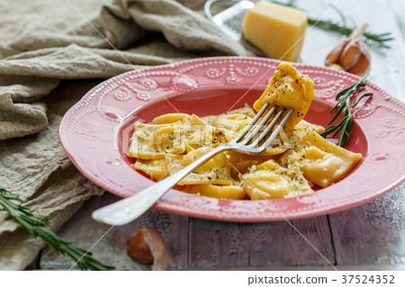 Delicious ravioli with parmesan and egg yolk. Delicious ravioli with parmesan and egg yolk. 37524352