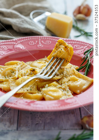 Fork in a plate of homemade ravioli. Fork in a plate of homemade ravioli. 37524353