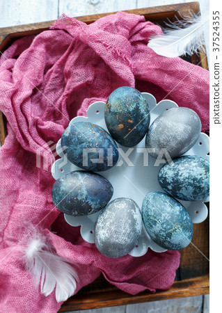 Blue Easter eggs on the stand. Blue Easter eggs on the stand. 37524355