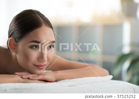 Sensual asian girl lying on massage table Sensual asian girl lying on massage table 37525252