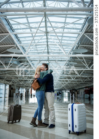 Happy male and female person hugging after flight Happy male and female person hugging after flight 37525514