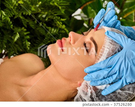 Dermal fillers of woman in spa salon with 37526280