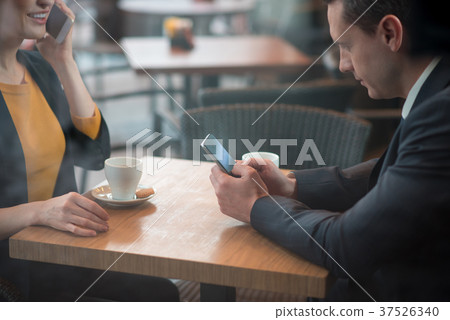 Outgoing partners working in cafe Outgoing partners working in cafe 37526340