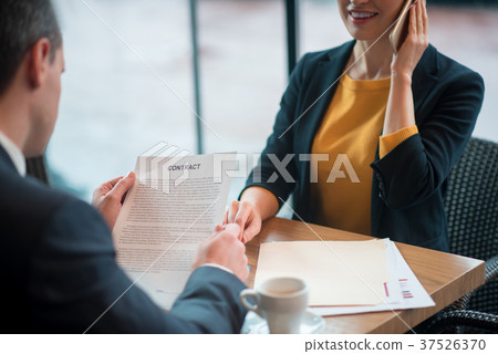 Male reading document near partner 37526370