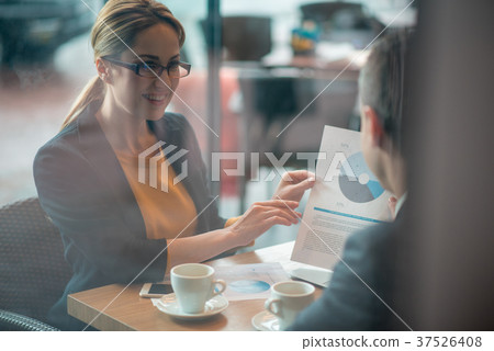 Outgoing lady showing statistics to partner 37526408